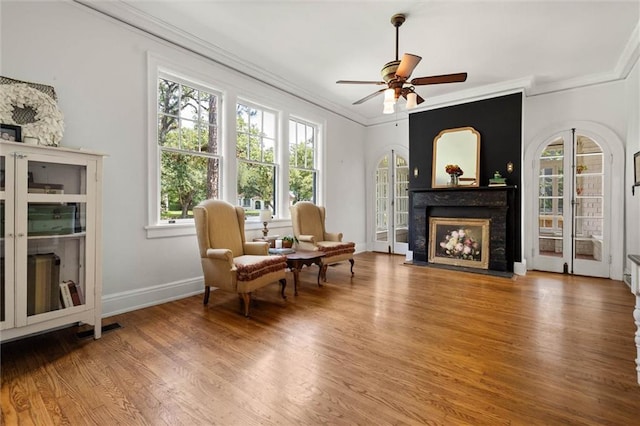 264 Mcdonald Ave, Mobile, AL 36604 - living area with crown molding, wood finished floors, healthy amount of natural light, and ceiling fan