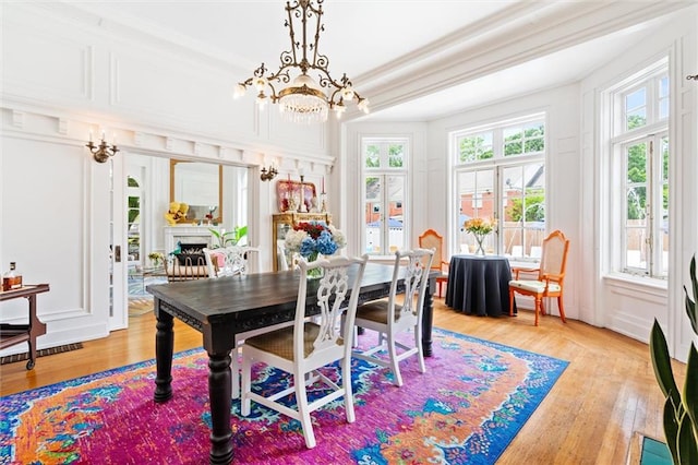 dining area featuring a healthy amount of sunlight and hardwood / wood-style floors