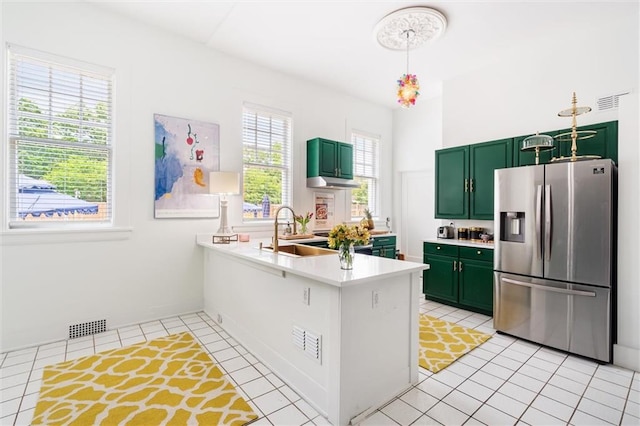 kitchen featuring sink, stainless steel fridge with ice dispenser, green cabinets, and light tile floors