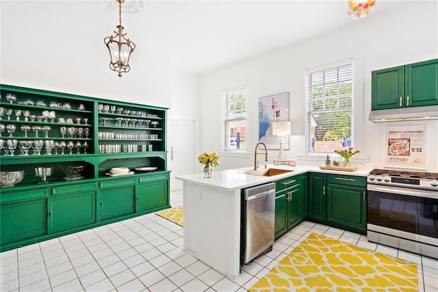 kitchen featuring green cabinetry, stainless steel appliances, pendant lighting, light tile floors, and sink