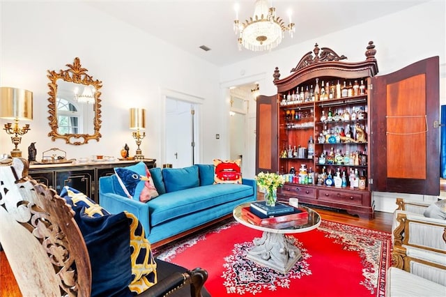 living room featuring bar area and hardwood / wood-style flooring