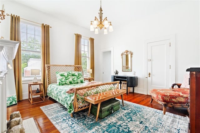 bedroom with multiple windows, hardwood / wood-style flooring, and a chandelier