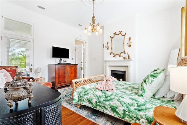 bedroom with hardwood / wood-style flooring and a chandelier