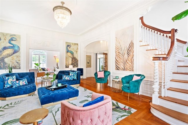 living room featuring an inviting chandelier and ornamental molding