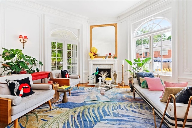 sitting room with a premium fireplace, hardwood / wood-style flooring, and crown molding