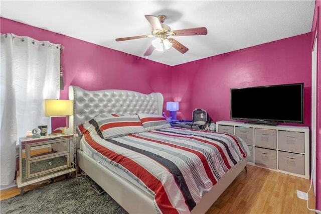 bedroom with ceiling fan and light hardwood / wood-style floors