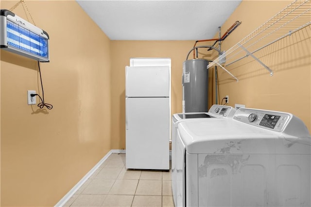 washroom with separate washer and dryer, light tile patterned floors, and water heater