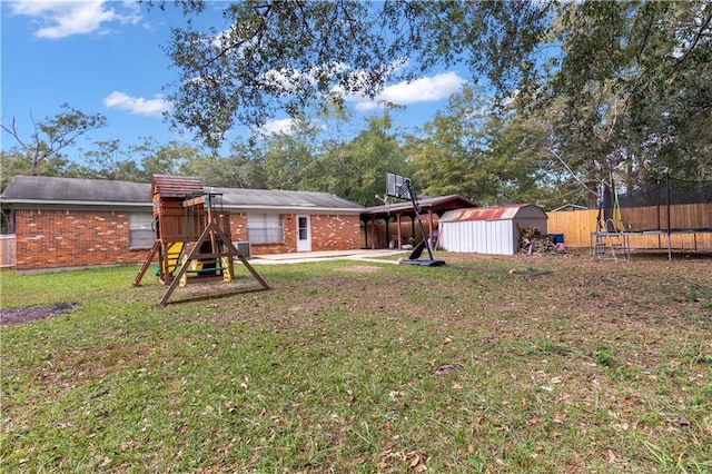 view of yard featuring a playground, a shed, and a trampoline