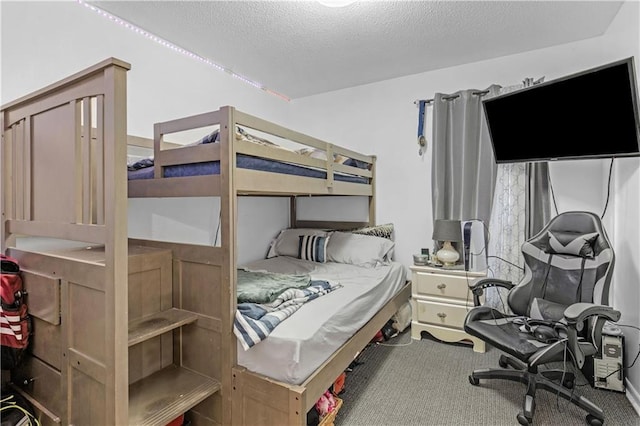 bedroom with carpet floors and a textured ceiling