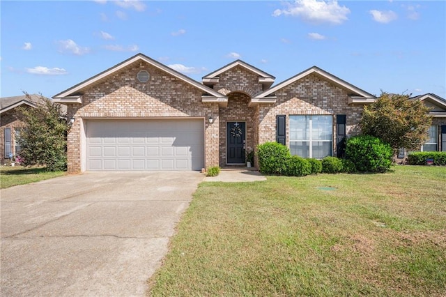 view of front of house with a garage and a front lawn