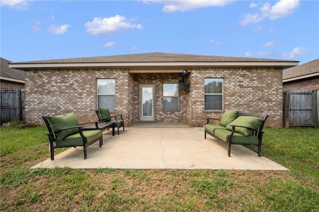 rear view of property featuring a patio area and a yard