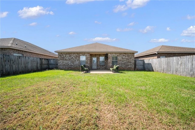 back of house featuring a yard and a patio area