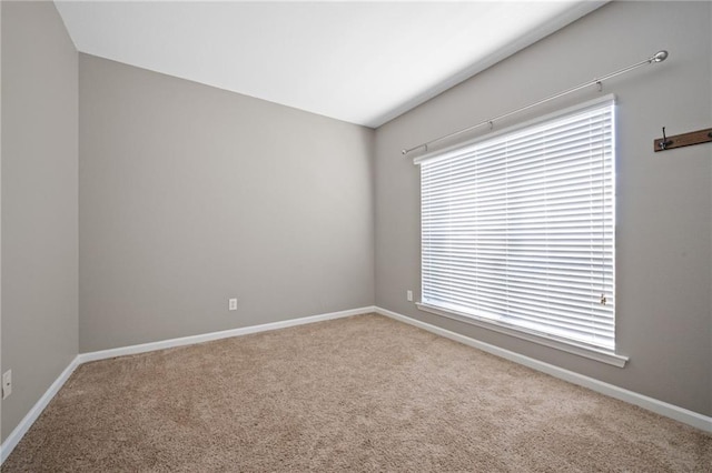 spare room featuring a healthy amount of sunlight and light colored carpet