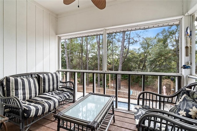 sunroom / solarium featuring ceiling fan