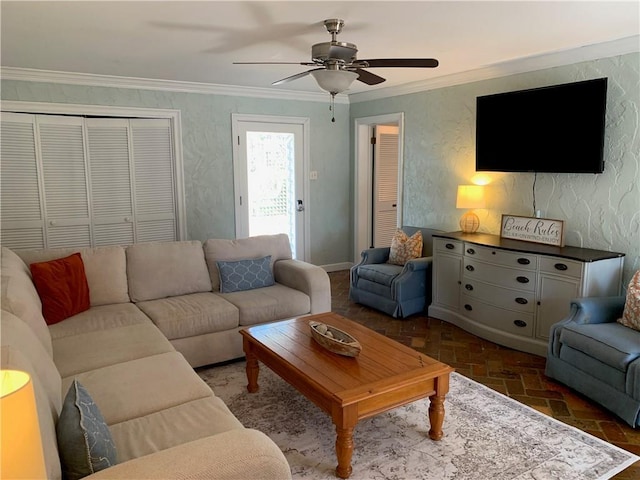 living area featuring ceiling fan, brick floor, and crown molding