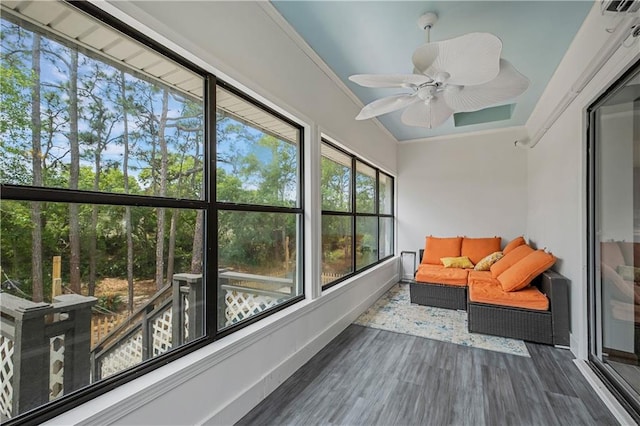 sunroom / solarium featuring a healthy amount of sunlight and a ceiling fan