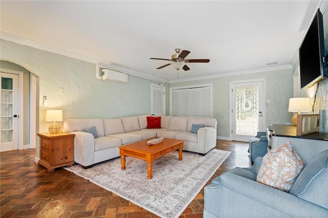 living area with arched walkways, a ceiling fan, a wall mounted air conditioner, brick floor, and crown molding