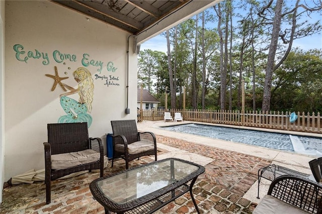 view of pool with a fenced in pool, a patio area, and fence