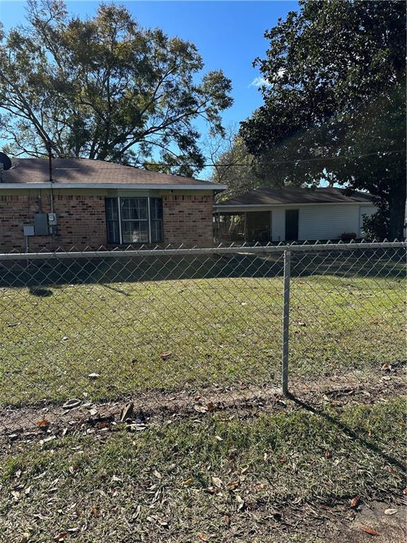 rear view of property featuring a yard