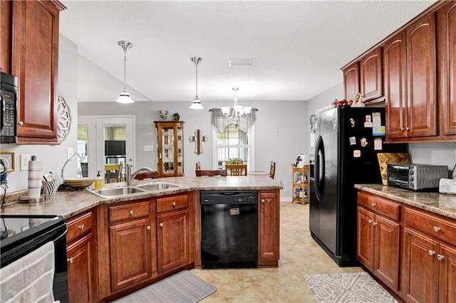 10628 Johnson Rd S, Mobile, AL 36695 - kitchen featuring black appliances, a peninsula, a chandelier, decorative light fixtures, and brown cabinetry
