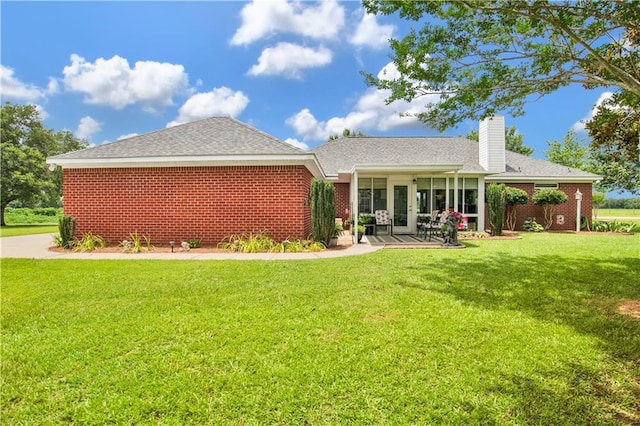 10628 Johnson Rd S, Mobile, AL 36695 - back of property with a yard, a chimney, and a patio area