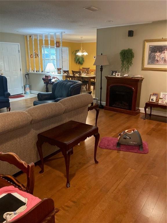 living room featuring hardwood / wood-style floors and a textured ceiling