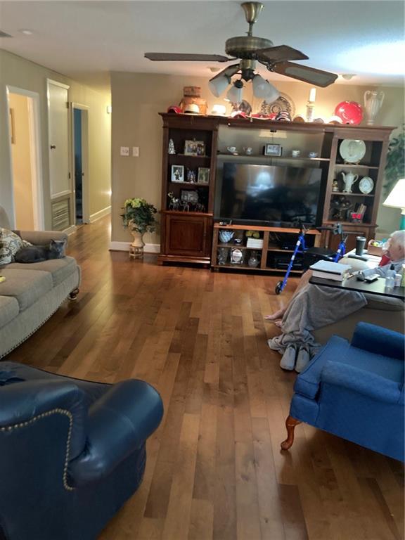 living room featuring hardwood / wood-style flooring and ceiling fan