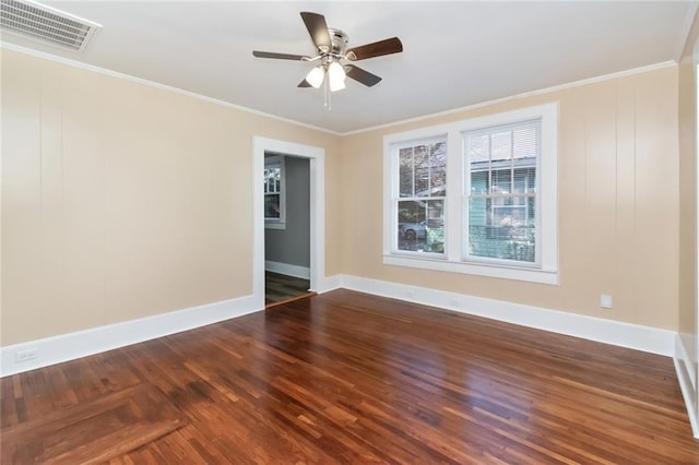 empty room featuring ceiling fan, crown molding, and dark hardwood / wood-style floors