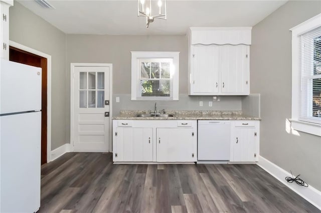 kitchen featuring white appliances, white cabinets, sink, dark hardwood / wood-style floors, and light stone counters