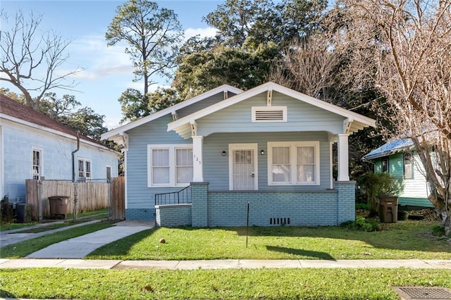 bungalow-style home with a front lawn