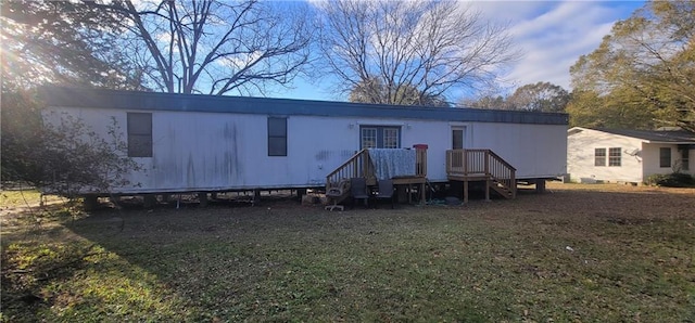 rear view of house featuring a yard