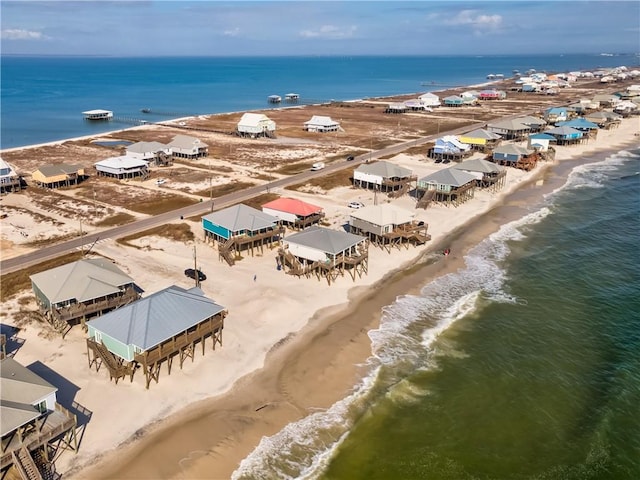 birds eye view of property with a beach view and a water view