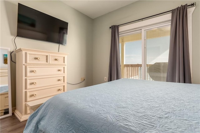 bedroom featuring dark wood finished floors and access to exterior