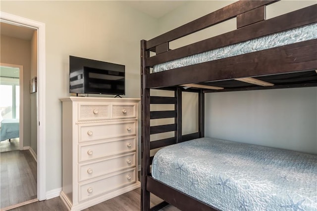 bedroom featuring baseboards and wood finished floors