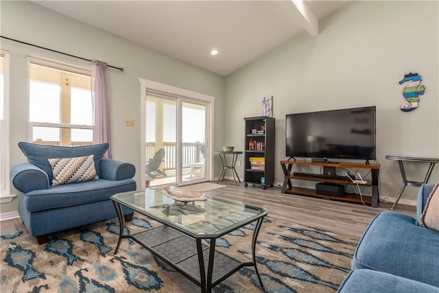 living area with lofted ceiling with beams, light wood finished floors, recessed lighting, and baseboards