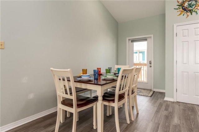 dining room with baseboards and dark wood-style flooring