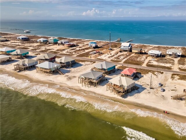 aerial view with a water view and a beach view