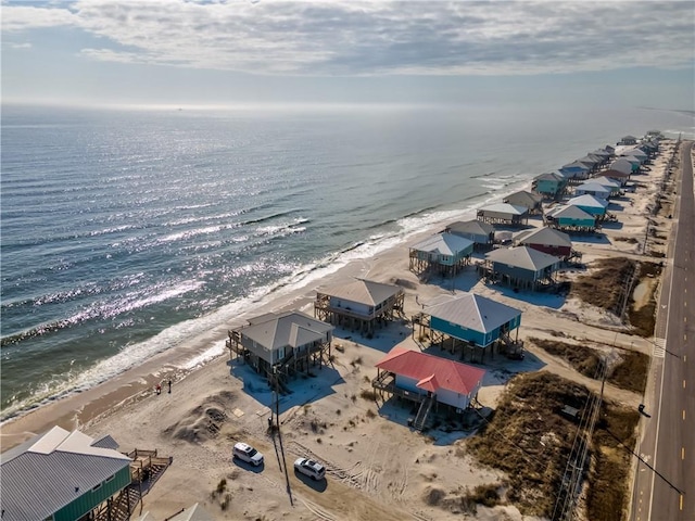 bird's eye view featuring a water view and a beach view