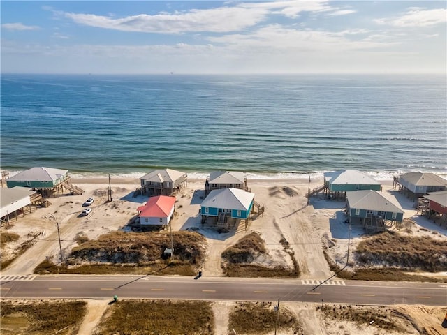 bird's eye view with a water view and a beach view