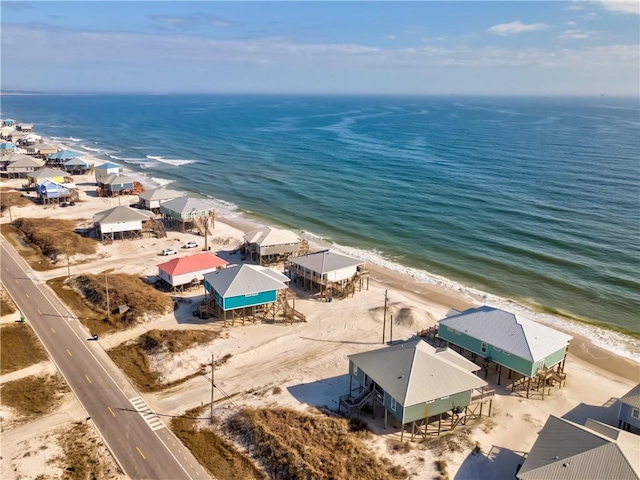 drone / aerial view featuring a water view and a beach view