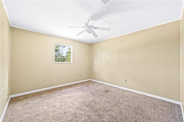 spare room with ceiling fan, a textured ceiling, crown molding, and carpet