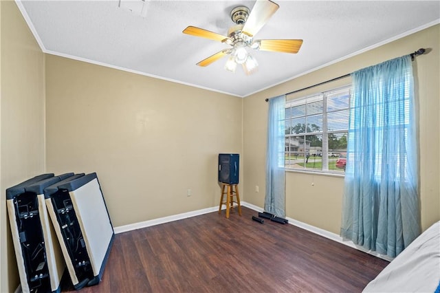 interior space with ornamental molding, dark hardwood / wood-style flooring, and ceiling fan