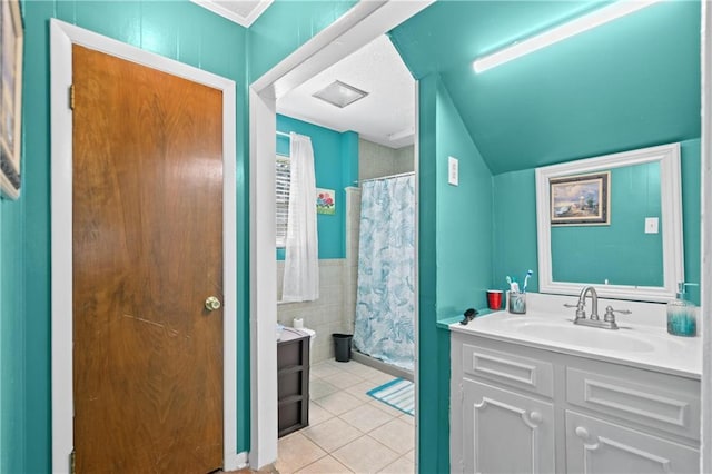 bathroom featuring tile walls, tile patterned flooring, a shower with curtain, and vanity