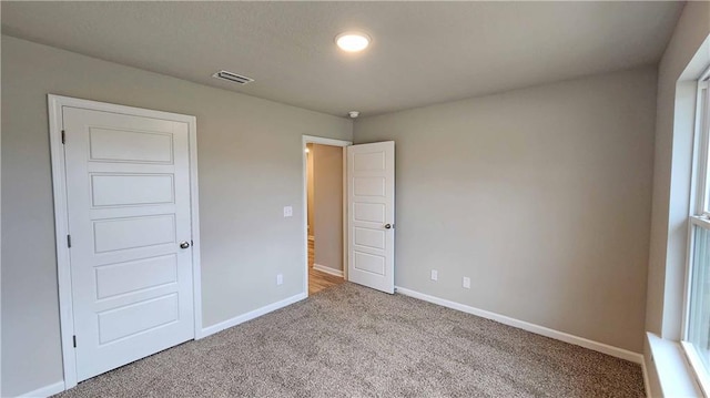 5189 Pinyon Dr, Mobile, AL 36693 - unfurnished bedroom featuring carpet, visible vents, and baseboards
