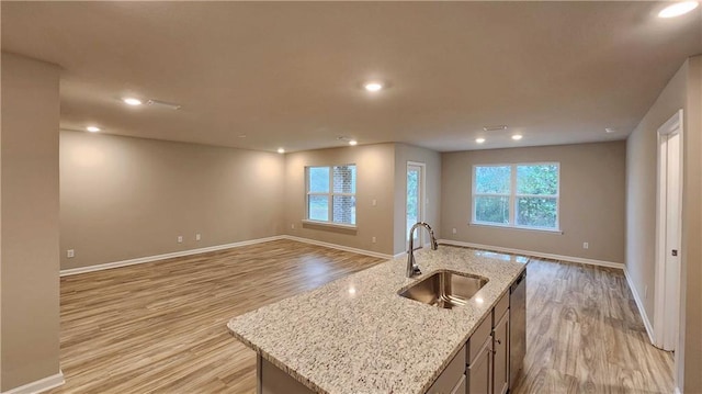 5189 Pinyon Dr, Mobile, AL 36693 - kitchen featuring baseboards, open floor plan, a sink, and light wood-style floors