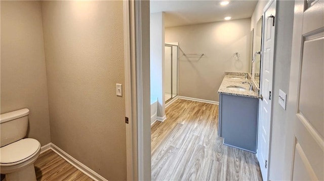 5189 Pinyon Dr, Mobile, AL 36693 - full bathroom featuring toilet, wood finished floors, a stall shower, vanity, and baseboards