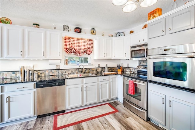 kitchen featuring sink, white cabinetry, and stainless steel appliances