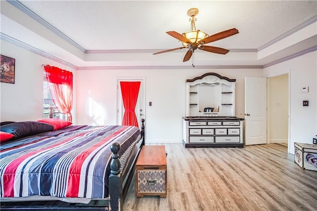 bedroom featuring crown molding, ceiling fan, a textured ceiling, and hardwood / wood-style flooring