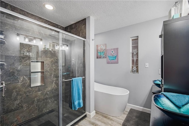 bathroom featuring wood-type flooring, a textured ceiling, and independent shower and bath