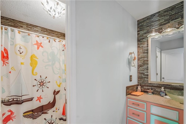 bathroom featuring vanity and curtained shower